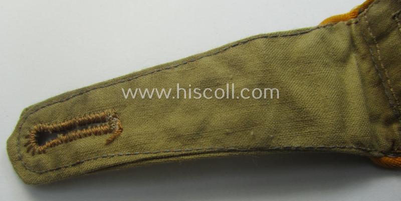 Single, WH (Luftwaffe) tropical-issued, NCO-type-shoulderstrap as executed in beige-coloured linnen (as was specifically intended for usage on the tropical-shirts ie. tunics) as was intended for an: 'Feldwebel der Flieger- o. FJ-Trpn.'