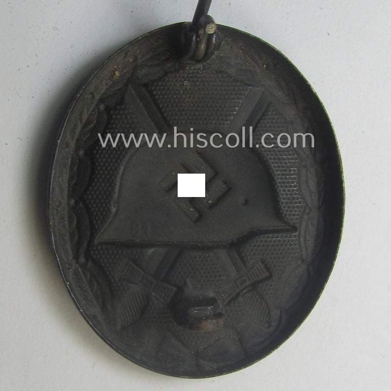 Neatly (double!) maker- (ie. '81'-) marked example of a black-class wound-badge (or: 'Verwundeten-Abzeichen in Schwarz') being an example that was produced by the maker (ie. 'Hersteller') named: 'Overhoff & Cie.'
