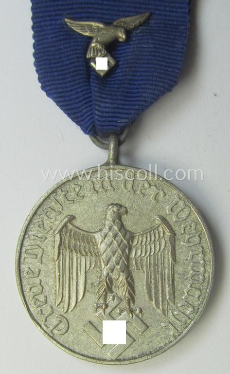 WH (Luftwaffe) bright silver-toned 'WH-DA der 4. Klasse für 4 Jahre Dienstzeit' that comes mounted onto its accompanying ribbon (ie. 'Bandabschnitt') having a silver-toned eagle-device attached