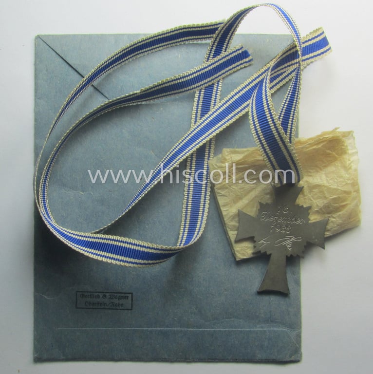 'Ehrenkreuz der deutschen Mutter - zweite Stufe' (or: silver-class mothers'-cross) that came mounted onto its long-sized ribbon and that came stored in its period pouch by the maker: 'Gottlieb & Wagner - Oberstein/Nahe'
