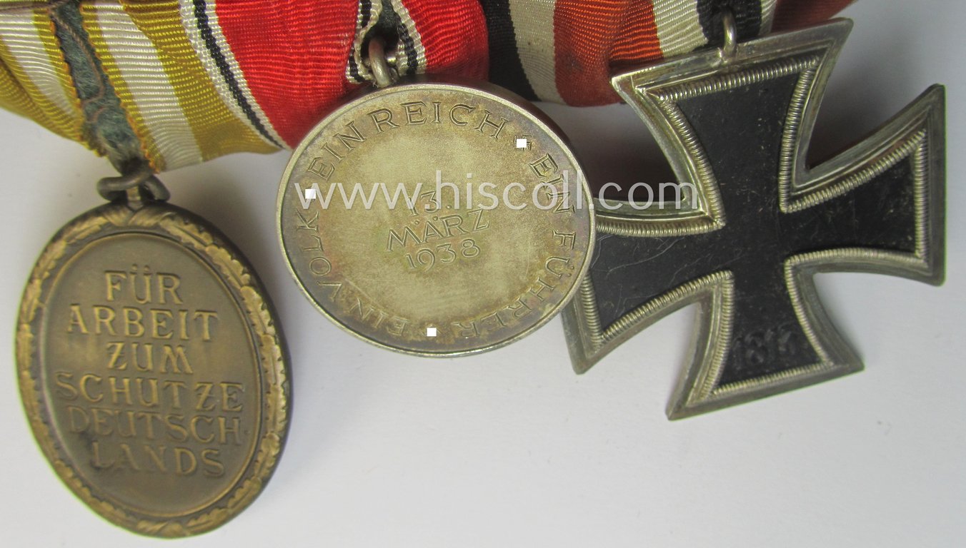 3-pieced, WWII- (ie. TR-) period medal-bar (ie. 'Ordenspange') showing resp. an: 'EKII.Kl.', an Austrian 'Anschluss'-medal '13. März 1938' and a: 'Westwall'-medal