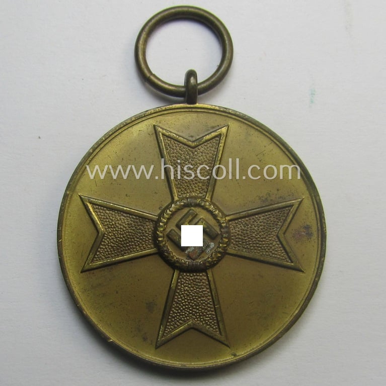 'Kriegsverdienstmedaille 1939' being a non-maker-marked- (and/or: typical 'Fenzink'-based) specimen that came together with its confectioned and shortened ribbon (ie. 'Bandabschnitt')