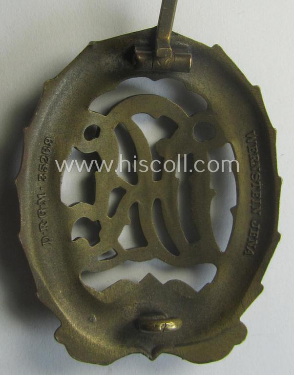 'Reichssportabzeichen DRL in Bronze' (or: bronze class DRL sports'-badge) being a just moderately worn- ie. used example that is nicely maker- (ie. 'Wernstein - Jena'-) marked on its back
