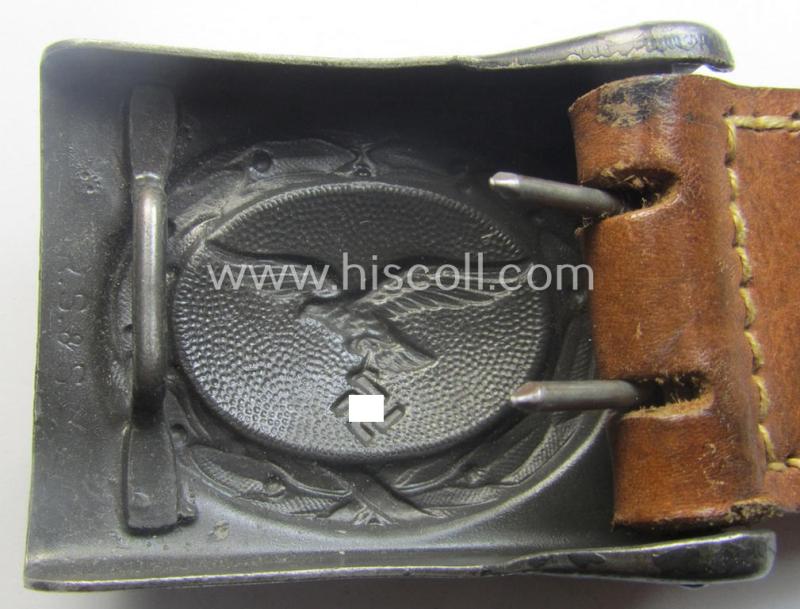 WH (Luftwaffe) darker-blue-coloured- and/or steel-based belt-buckle, being a neatly maker- (ie. 'R. Sieper & Söhne'-) marked and/or: '1942'-dated example that comes mounted onto its period, natural-coloured and/or leather-based tab