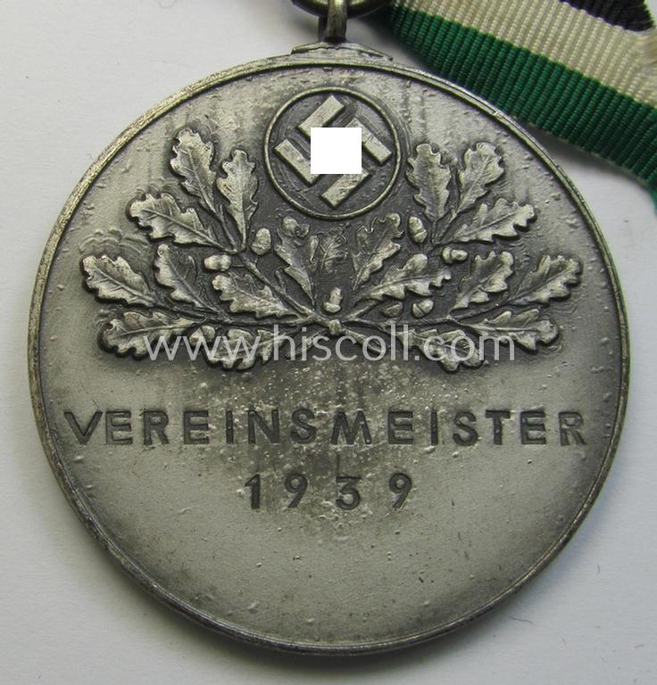 Superb - and most certainly unusually seen! - frosted-silver-toned, TR-period shooting-medal showing on its front a uniformed hunter and that is entitled: 'Vereinsmeister 1939' and that comes mounted onto its 'bow-tie-shaped' ribbon as issued