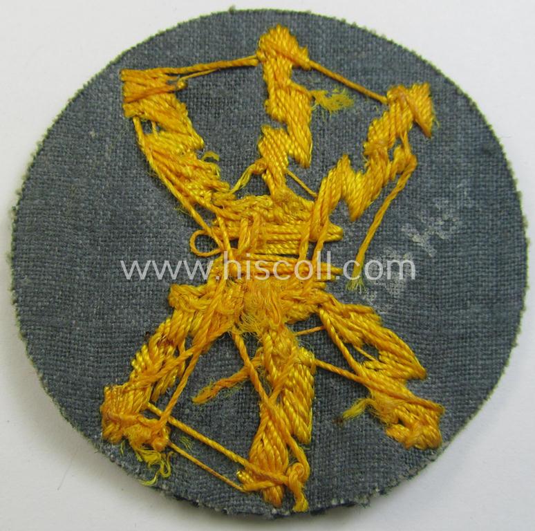 Attractive, WH (Heeres) so-called: trade- and/or special career arm-insignia as was intended for a: 'Funkmeister', being a neatly hand-embroidered variant on darker-green-coloured wool