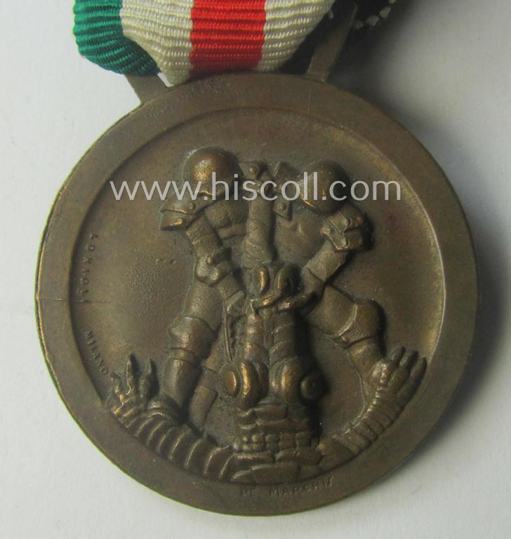 Golden-bronze-coloured (and 'Buntmetall'-based!) example of a: 'Deutsch-Italienische Feldzugsmedaille' (or: German-Italian campaign-medal) that came mounted onto its (full length- and 'virtually mint- ie. unissued') piece of original ribbon