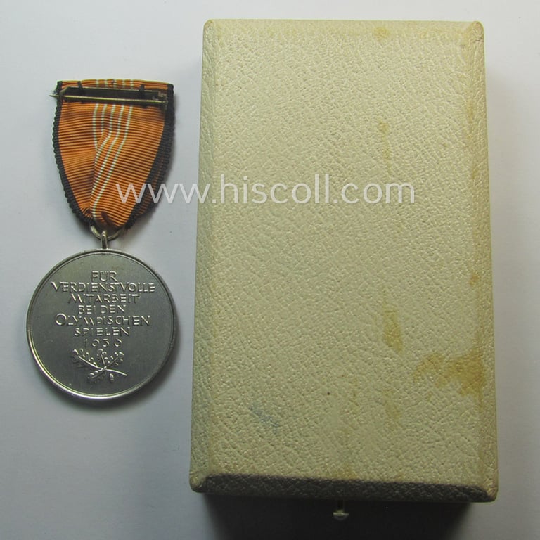 Superb, 'Deutsche Olympia-Erinnerungsmedaille 1936' being a non-maker-marked example that comes mounted onto its original ribbon (ie. 'Bandabschnitt') and that comes stored in its typical, beige-white-coloured etui