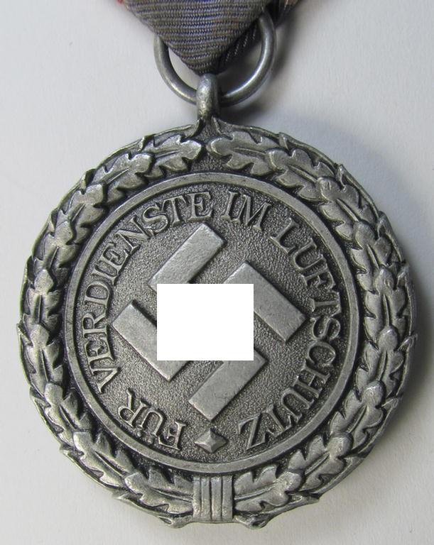 Neat, 'Luftschutz-Ehrenzeichen 2. Stufe' being a non-maker-marked example, as executed in (heavy) zinc-based metal (ie. 'Feinzink') and that comes mounted onto its period ribbon ie. 'Bandabschnitt'