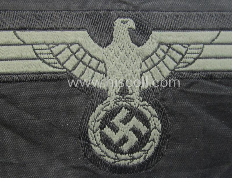 Later- (ie. mid-war-) period, WH (Heeres) 'Panzer'-type breast-eagle (ie. 'Brustadler für Panzertruppen') being a 'virtually mint- ie. unissued' example as executed in bluish-grey-coloured linnen on a black-coloured background