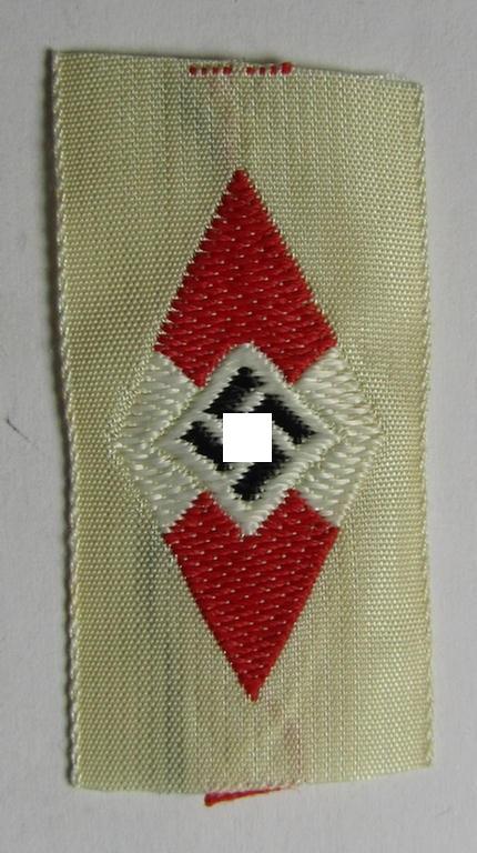 HJ (ie. 'Hitlerjugend') cap-badge (ie.: 'Raute') being a bright-red-coloured- and/or detailed example that is executed in the neat 'BeVo'-weave-pattern