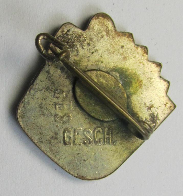 Attractive, silverish-coloured and 'Buntmetall'-based, N.S.D.A.P.-related lapel-pin (ie. 'Mitgliedsabzeichen') being a commemorative example that shows a sowing farmer-figure surrounded by an enamelled: 'Sunburst'-swastika