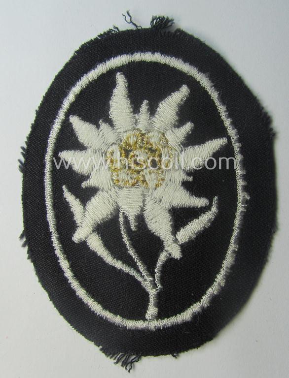 Waffen-SS-pattern, black-coloured sleeve-insignia (ie. 'Ärmelabzeichen') depicting an: 'Edelweiss'-flower as used by the various 'Gebirgsjäger'- (ie. mountain-troops-) related divisional-staff