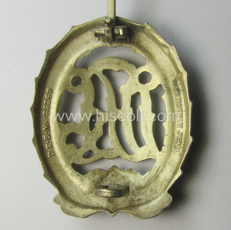 'Reichssportabzeichen DRL in Silber' (or: silver-class DRL sports'-badge) being a maker- (ie. 'Wernstein - Jena'-) marked example and that comes with its accompanying miniature