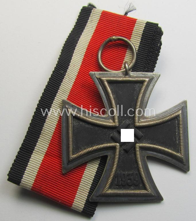 'Eisernes Kreuz II. Klasse' being a maker- (ie. '44'-) marked example that comes together with its (mint- and full length) ribbon (ie. 'Bandabschnitt') as was produced by the maker (ie. 'Hersteller'): 'Jakob Bengel - Oberstein'
