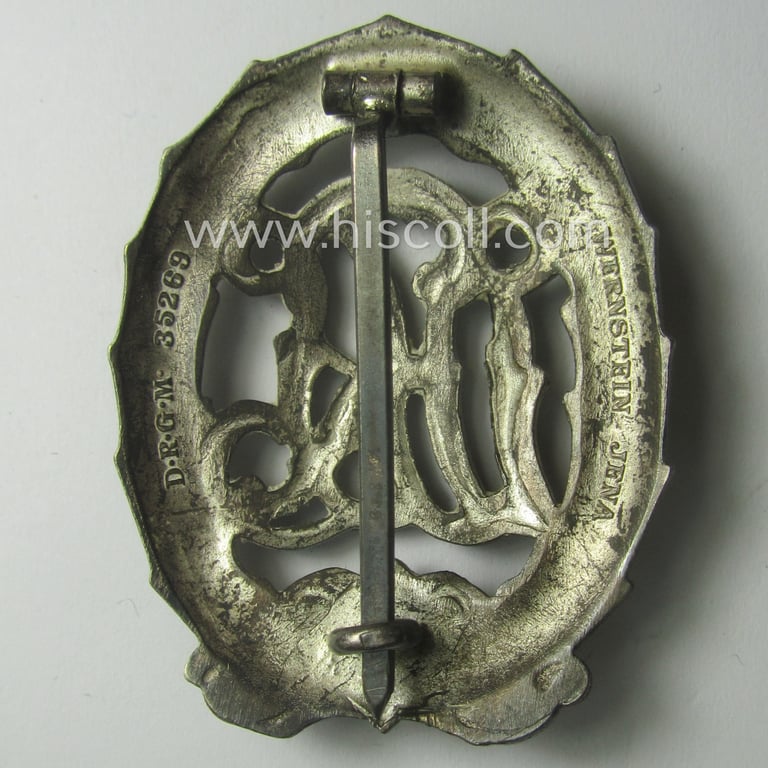 'Reichssportabzeichen DRL in Silber' (or: DRL sports'-badge in silver) being a just moderately worn- ie. used example that is nicely maker- (ie. 'Wernstein - Jena'-) marked on its back