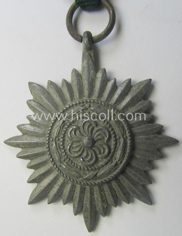 WH-related so-called: 'Verdienstauszeichnung für Angehörige der Ostvölker, 2. Klasse in Silber ohne Schwerter', being a typical non-maker-marked- and/or: 'Feinzink'-based example that comes mounted on its period ribbon