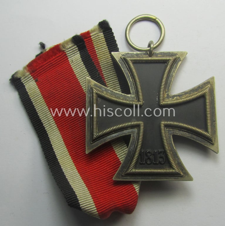 Iron Cross 2nd class (or: 'EK II. Klasse') being a maker- (ie. '120'-) marked example that comes together with its original ribbon (ie. 'Bandabschnitt') as was produced by the (not that often seen!): 'Franz Petzl'-company
