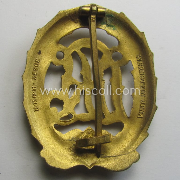 Superb, 'Reichssportabzeichen DRL in Gold' (or: golden-class DRL sports'-badge) being a maker- (ie. 'Wernstein - Jena'-) marked example and that comes with its accompanying miniature