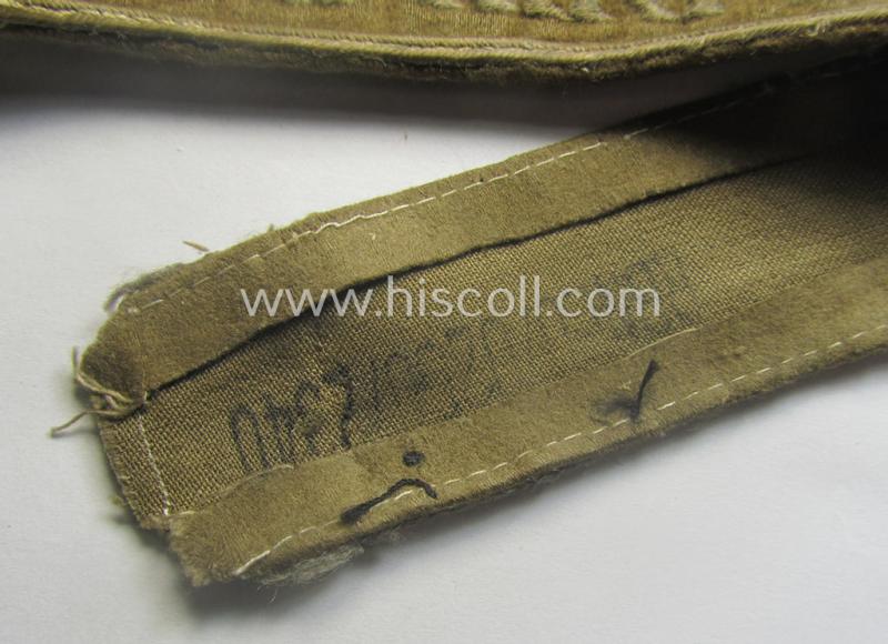WH cuff-title (ie. 'Ärmelstreifen') entitled: 'Afrika' (being an example that bears a printed 'RbN.'-numeral ('RBN.0/0250/2340') and that comes in an issued, clearly worn- and/or most certainly once tunic-attached, condition)