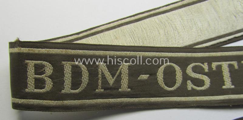 Superb - and rarely encountered! - example of the HJ/BDM- ('Hitlerjugend' ie. 'Bund Deutscher Mädel'-) cuff-title (ie. 'Ärmelstreifen') entitled: 'BDM-Osteinsatz' being an example as executed in the neat 'BeVo'-weave pattern