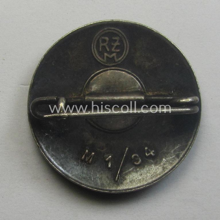 Neatly enamelled- (and bright-red-coloured!) 'N.S.D.A.P.'-membership-pin- ie. party-badge (or: 'Parteiabzeichen') which is nicely maker-marked on the back with the makers'-designation: 'RzM' and/or: 'M1/34'