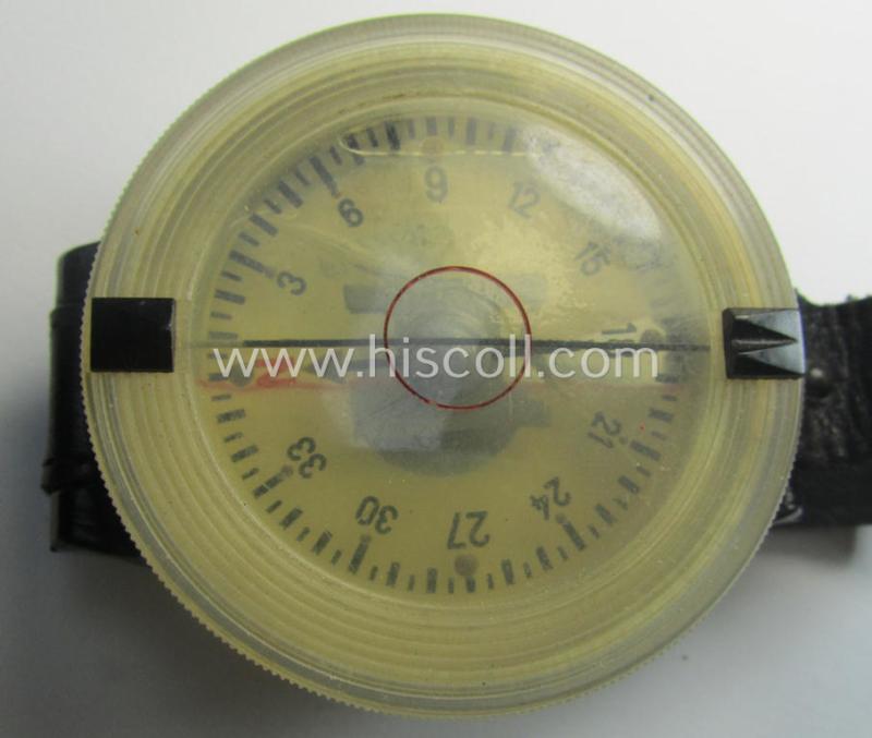 Attractive - and/or fully functional! - example of a WH (Luftwaffe) black-coloured- and/or resin-based, pilots'-armband-compass of the type: 'AK 39' that comes mounted onto its period, bluish-black-coloured strap as issued and/or used