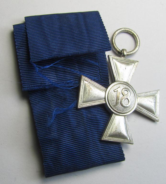 Bright-silver-toned WH (Heeres o. KM): 'WH-Dienstauszeichnung der 2. Stufe' (as was intended for 18 years of loyal-service) that comes together with its period ribbon (ie. 'Bandabschnitt') having a detailed eagle-device period-attached
