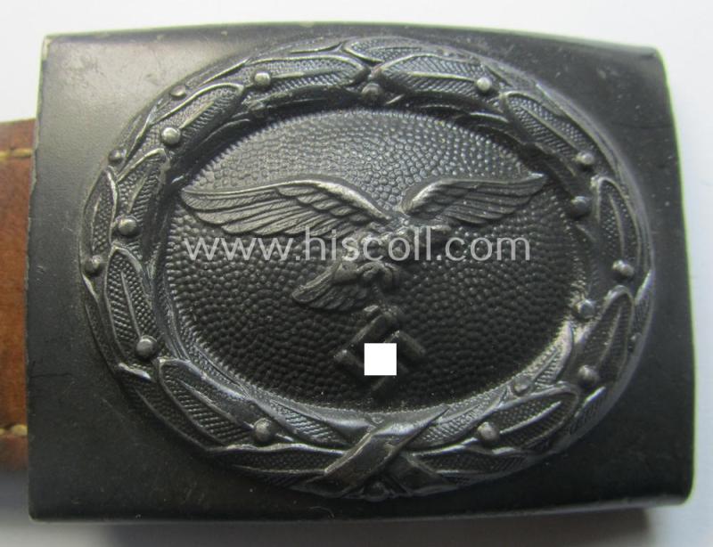 WH (Luftwaffe) darker-blue-coloured- and/or steel-based belt-buckle, being a neatly maker- (ie. 'R. Sieper & Söhne'-) marked and/or: '1942'-dated example that comes mounted onto its period, natural-coloured and/or leather-based tab