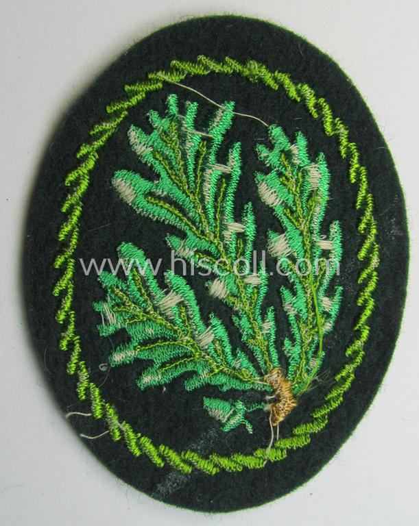 Attractive example of a WH (Heeres) so-called: 'Jäger'-armbadge being a neatly machine-embroidered- and/or multi-coloured version as was executed on darker-green-coloured wool