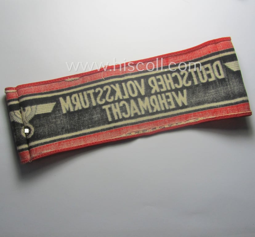 Typically printed- and/or later-war-period, bright-red- and/or black-coloured so-called: 'Deutscher Volkssturm'-armband (ie. 'Armbinde') that comes in an overall nice- (I deem just moderately used- and/or worn-), condition
