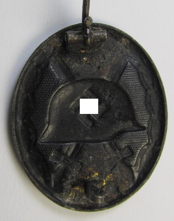 Moderately used- and maker- (ie. '32'-) marked example of a black-class wound-badge (or: 'Verwundeten-Abzeichen in Schwarz') being an example that was produced by the Austrian-based maker (ie. 'Hersteller') named: 'W. Hobacher'