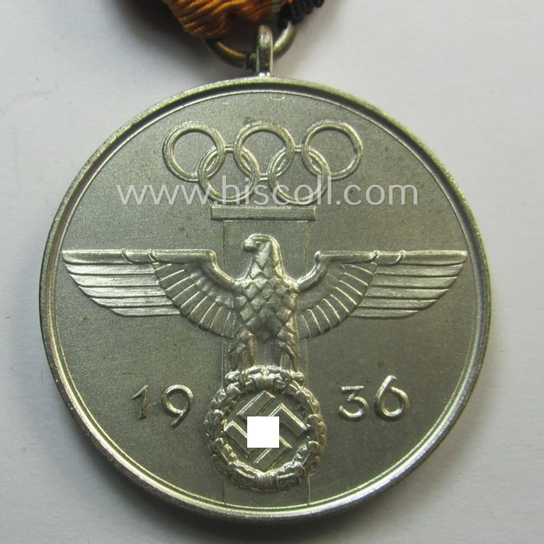 Superb, 'Deutsche Olympia-Erinnerungsmedaille 1936' being a non-maker-marked example that comes mounted onto its original ribbon (ie. 'Bandabschnitt') and that comes stored in its typical, beige-white-coloured etui