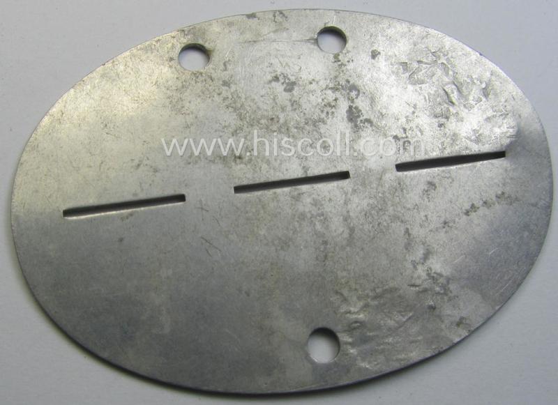 Aluminium-based WH (Luftwaffe) ie. 'Luftnachrichten'-related ID-disc (ie. 'Erkennungsmarke') bearing the stamped unit-designation that reads: 'Ln.Stelle mot - E63' and that comes stored in its period (linnen-based) pouch