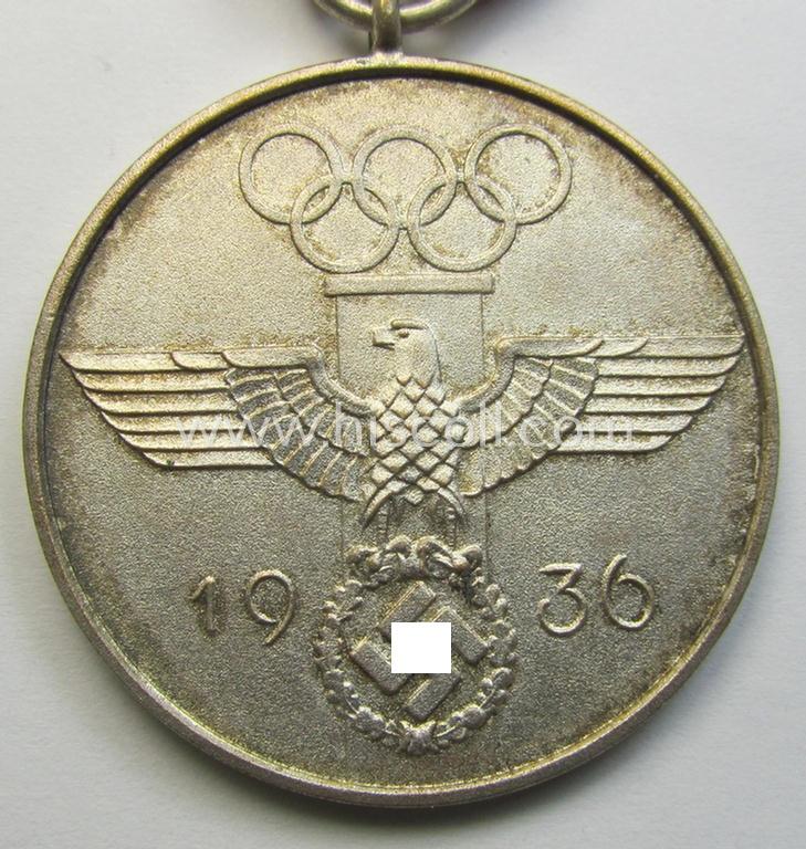 Superb, 'Deutsche Olympia-Erinnerungsmedaille 1936' being a non-maker-marked example that comes mounted onto its original ribbon (ie. 'Bandabschnitt') and that comes stored in its typical, beige-white-coloured etui as issued and stored for decade...