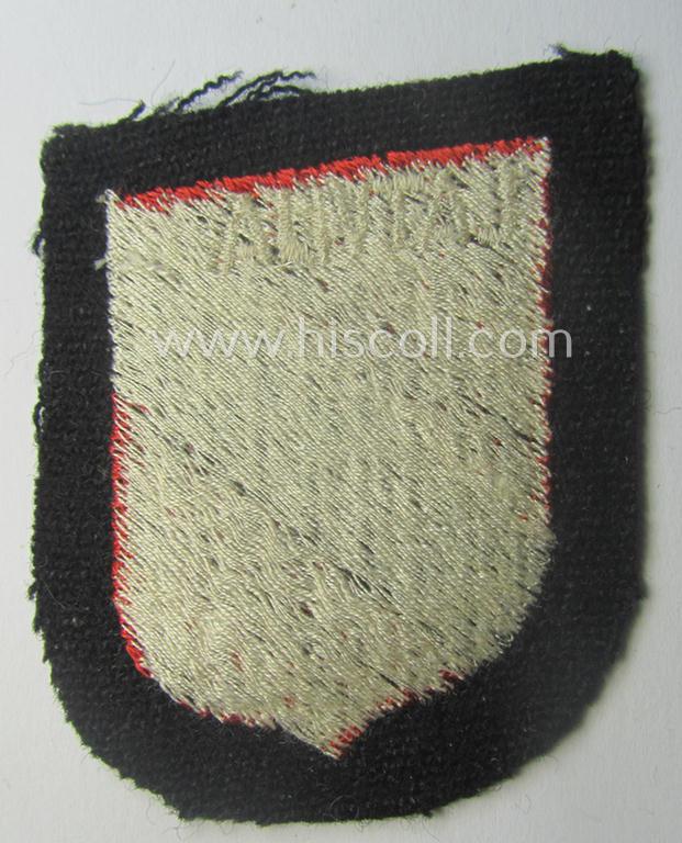 Waffen-SS 'volunteer'-arm-shield as was intended for usage by soldiers of the: '15. o. 19. Waffen-Grenadier-Division der SS' (ie. 'lettische nr. 1 o. 2') and that comes in a 'virtually mint- ie. unissued', condition
