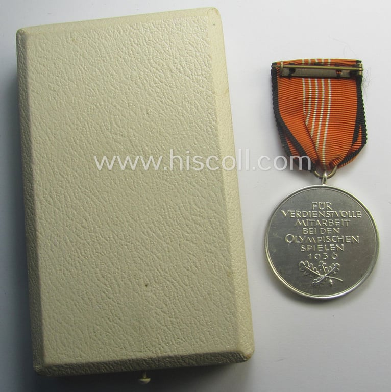 Superb, 'Deutsche Olympia-Erinnerungsmedaille 1936' being a non-maker-marked example that comes mounted onto its original ribbon (ie. 'Bandabschnitt') and that comes stored in its typical, beige-white-coloured etui