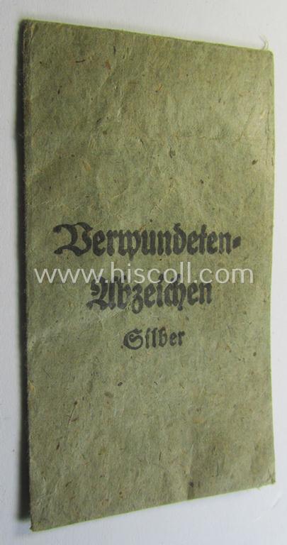 Attractive, silver-class wound-badge (or: 'Verwundeten-Abzeichen in Siber') being a non-maker-marked example that comes stored in its original, carton-based pouch as was produced by the maker (ie. 'Hersteller'): 'Steinhauer & Lück'