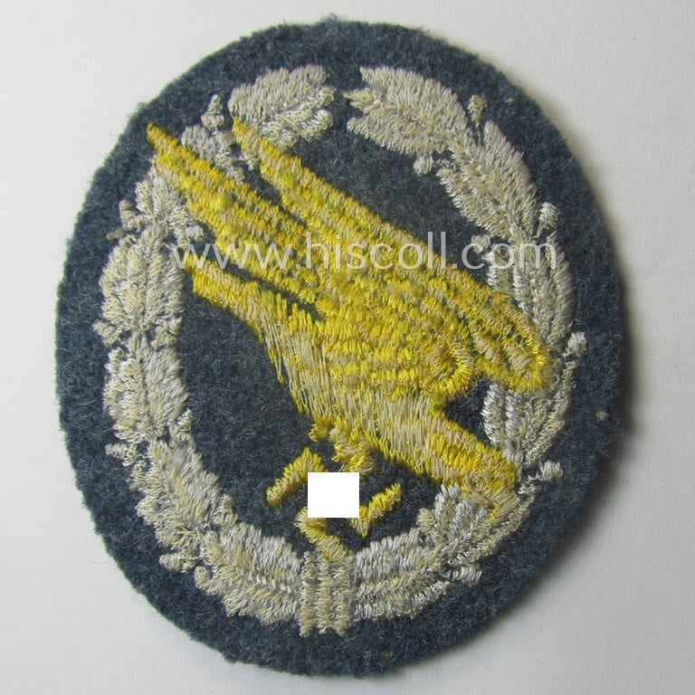 WH (LW) 'Fallschirmschützen-Abzeichen in Stoff' (or: cloth-based paratroopers'-jump-badge) being a nicely machine-embroidered specimen that comes in a probably issued albeit (I deem) never used- ie. 'virtually mint', condition