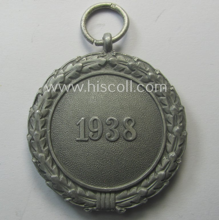 'Luftschutz-Ehrenzeichen 2. Stufe' being a maker- (ie. '10'-) marked example, as executed in (light-weight) aluminium-based metal and that came together with its period ribbon (ie. 'Bandabschnitt')