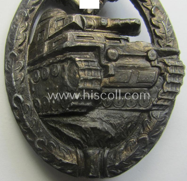 'Panzerkampfabzeichen in Silber' (or: silver-class panzer-assault badge or PAB) being a (typical) non-maker-marked- and/or hollow zinc- (ie. 'Feinzink'-) based example as was produced by the: 'Wilh. Deumer'-company