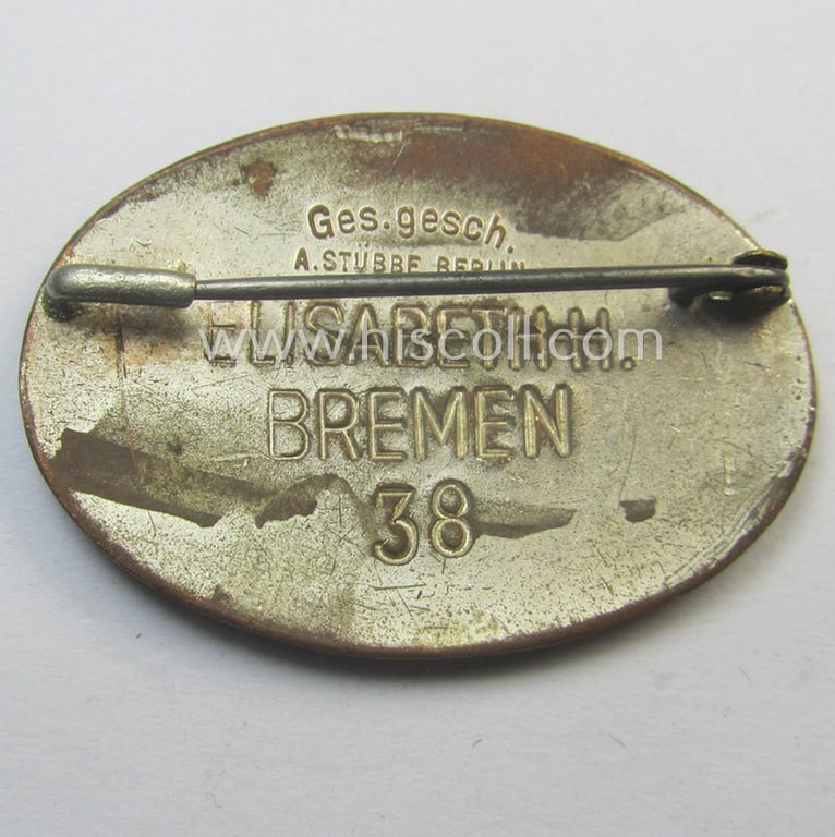 Attractive - and rarely seen! - DRK (ie. 'Deutsches Rotes Kreuz'): nurses'-badge entitled: 'Hilfsschwester' being an oval-shaped- and/or maker-marked specimen showing an engraved bearers'-number: ('38') and towns'-name: 'Elisabeth H. - Bremen'