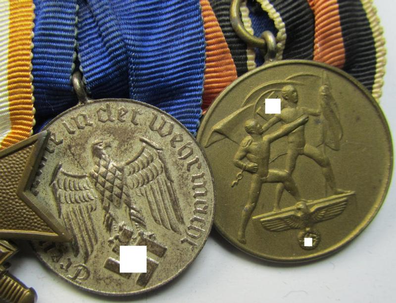 Attractive example of a three-pieced medal-bar (ie.: 'Ordenspange') resp. showing a: 'KvK 2. Klasse mit Schwertern', a: 'WH-DA 4. Stufe' (with firmly attached eagle-device) and a Czech 'Anschluss'-medal '1 Oktober 1938'