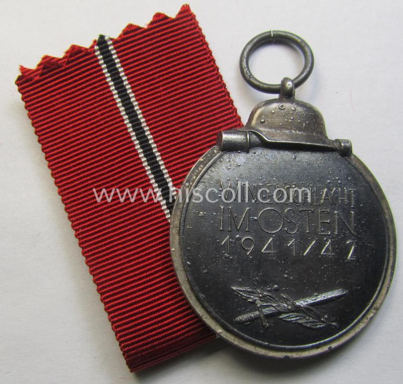 Attractive medal-set: 'Winterschlacht im Osten 1941-42' being a maker- (ie. '65'-) marked- (and/or 'Feinzink'-based) specimen by the maker: 'Klein & Quenzer' and that comes together with its (non-confectioned) ribbon (ie. 'Bandabschnitt')