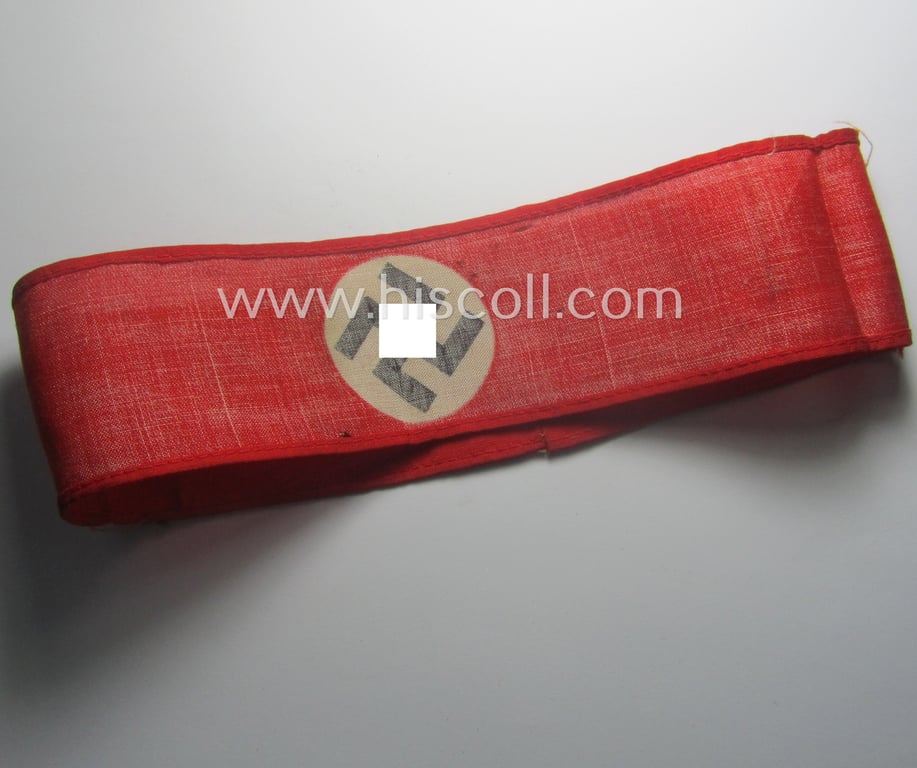 Truly worn, thin-shaped, 'N.S.D.A.P.'-related armband (ie. 'Armbinde') being of the 'entirely printed'-type showing a swastika-sign