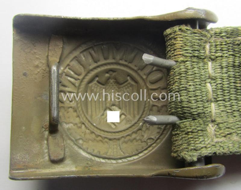 WH (Heeres) 'tropical-issued' belt-buckle being a non-maker-marked, field-grey-coloured example that comes mounted onto its original, greenish-coloured- (and/or: 'webbing'-based-) tab