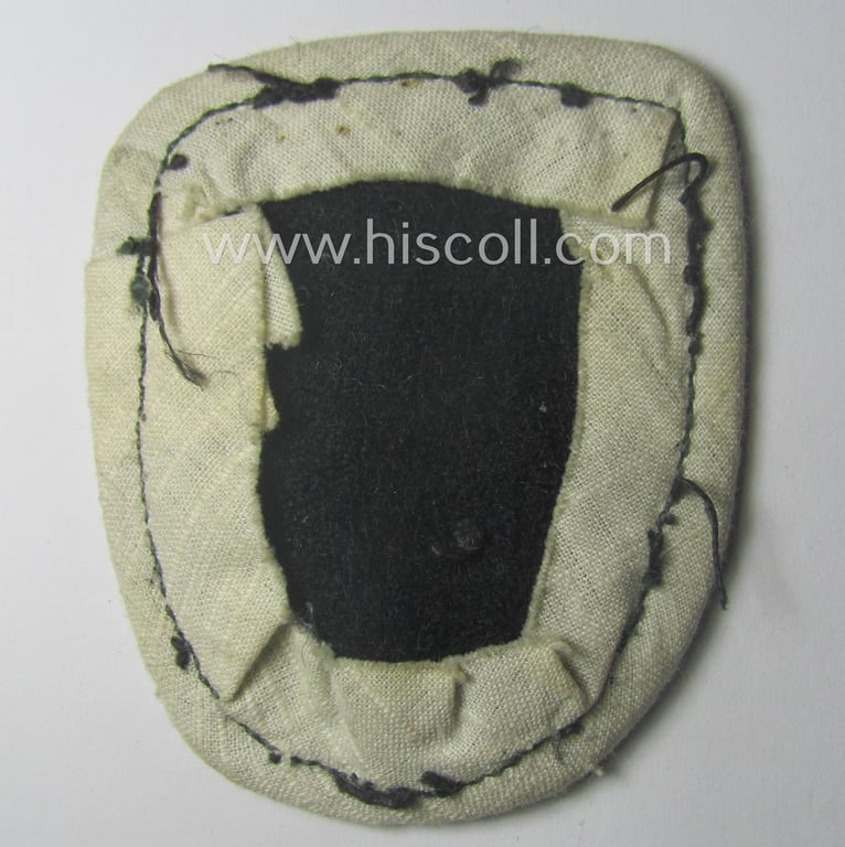 WH (Heeres) so-called: 'Truppen-Traditionsabzeichen o. Ärmelshild des 23. Panzer-Division' (being a golden-toned example as executed in copper-based metal that comes period-mounted on a woolen-based 'backing' as worn)