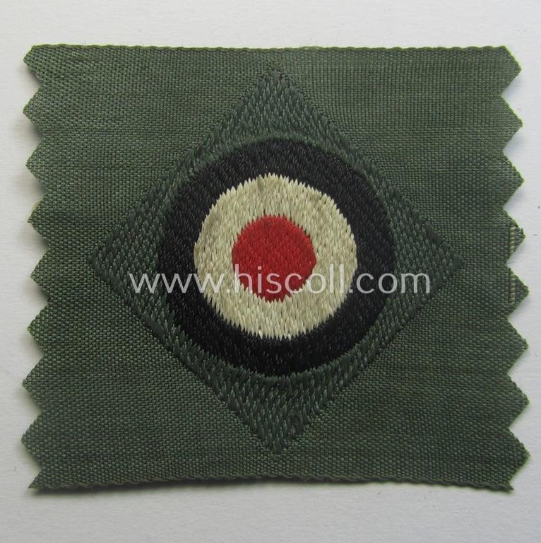 Early- (ie. mid-) war-period, WH (Heeres) cap-eagle & cocarde-set (ie. 'Schiffchenmützen-Adler u. Kokarde-Satz für Mannschaften u. Uffz.') being a 'virtually mint' set as executed in bluish-grey-coloured linnen on a field-grey-coloured background