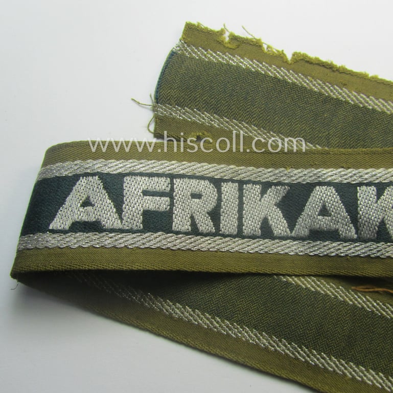 Truly worn, 'BeVo'-like cuff-title (ie. 'Ärmelstreifen') entitled: 'Afrikakorps' being a with certainty issued example that comes in an overall nice- (ie. hardly shortened- and/or once tunic-attached-), condition