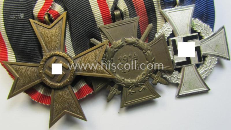 Three-pieced medal-bar (ie. 'Ordenspange') respectively depicting a: 'KvK II.Klasse o. Schw.', a: WWI-period: 'Frontkämpferkreuz 1914-18' (ie.: 'Kriegsteilnehmerkreuz mit Schwertern') and a: 'Treuedienst Ehrenzeichen 2. Klasse'
